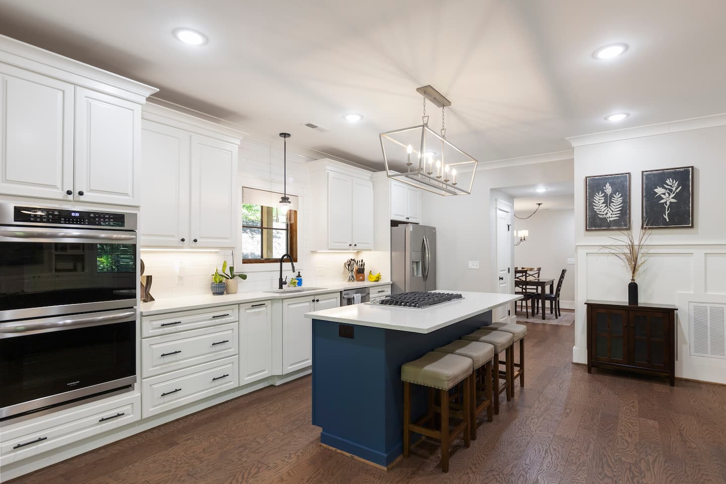 The kitchen's navy island and white cabinetry