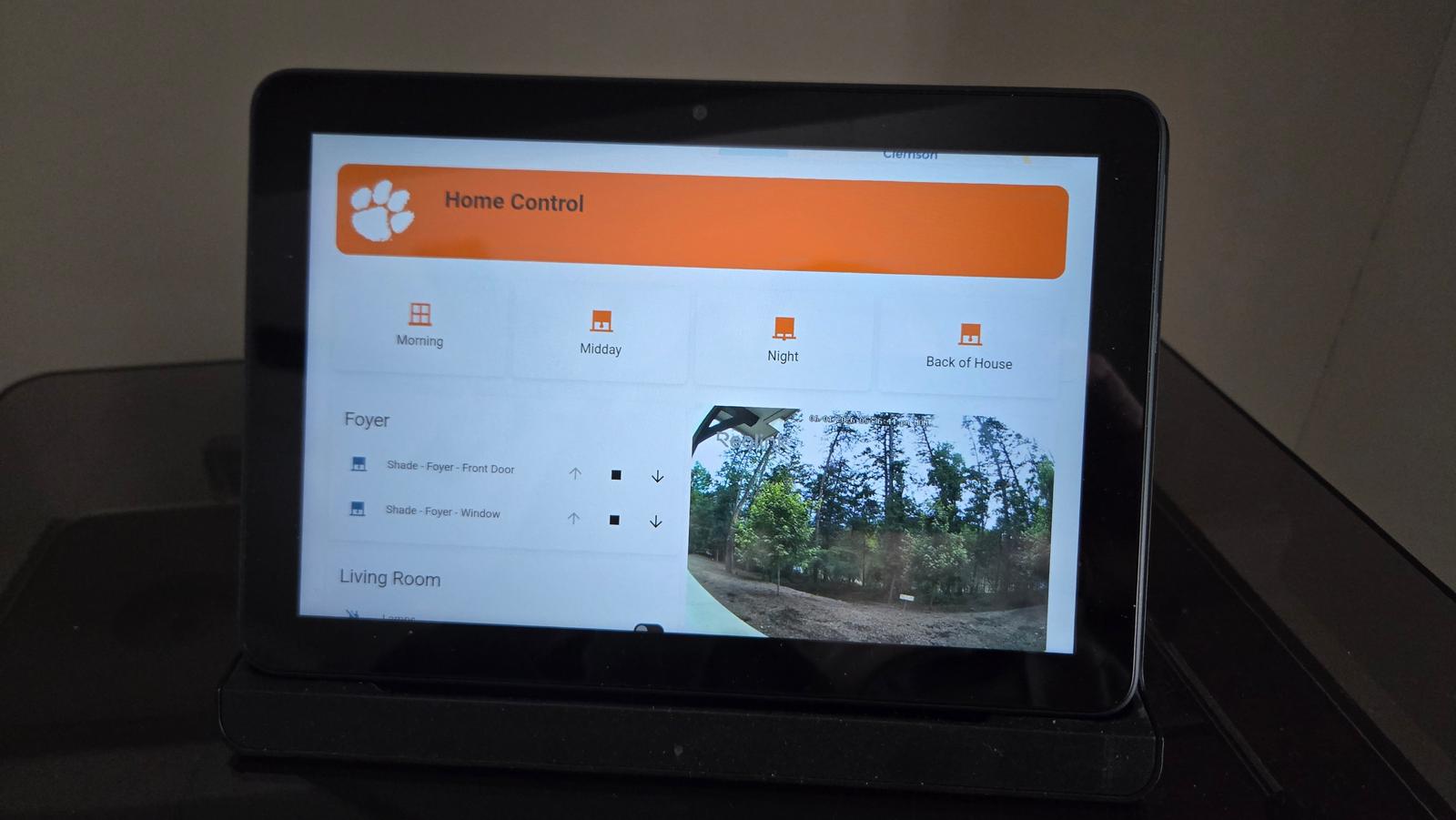 Guest kiosk screen with one-tap scenes, shade controls, and a live look at the driveway