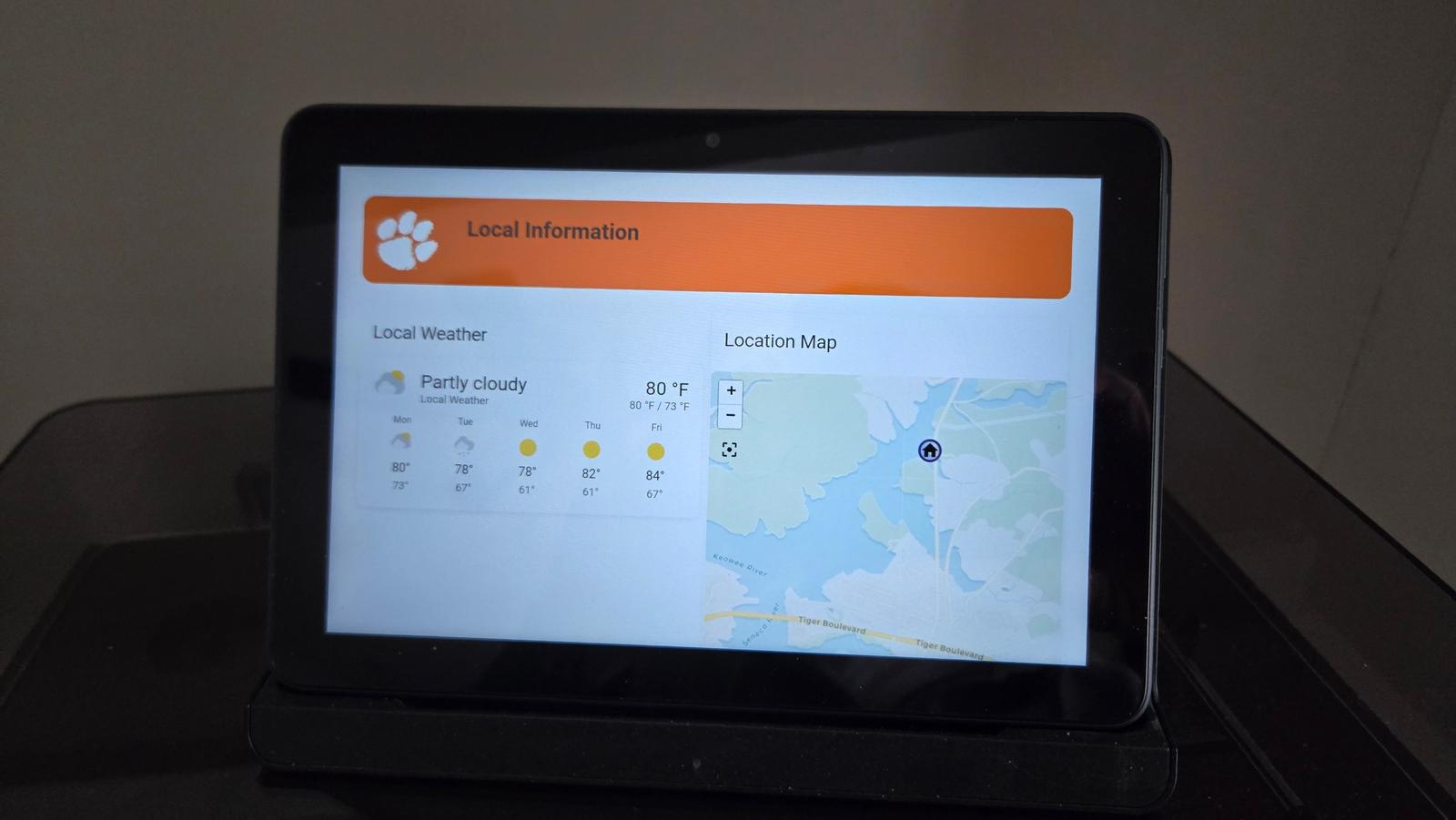 Guest kiosk screen showing the local weather forecast and a map of the area