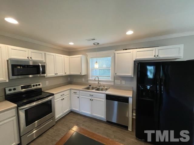The kitchen — white cabinets and stainless appliances