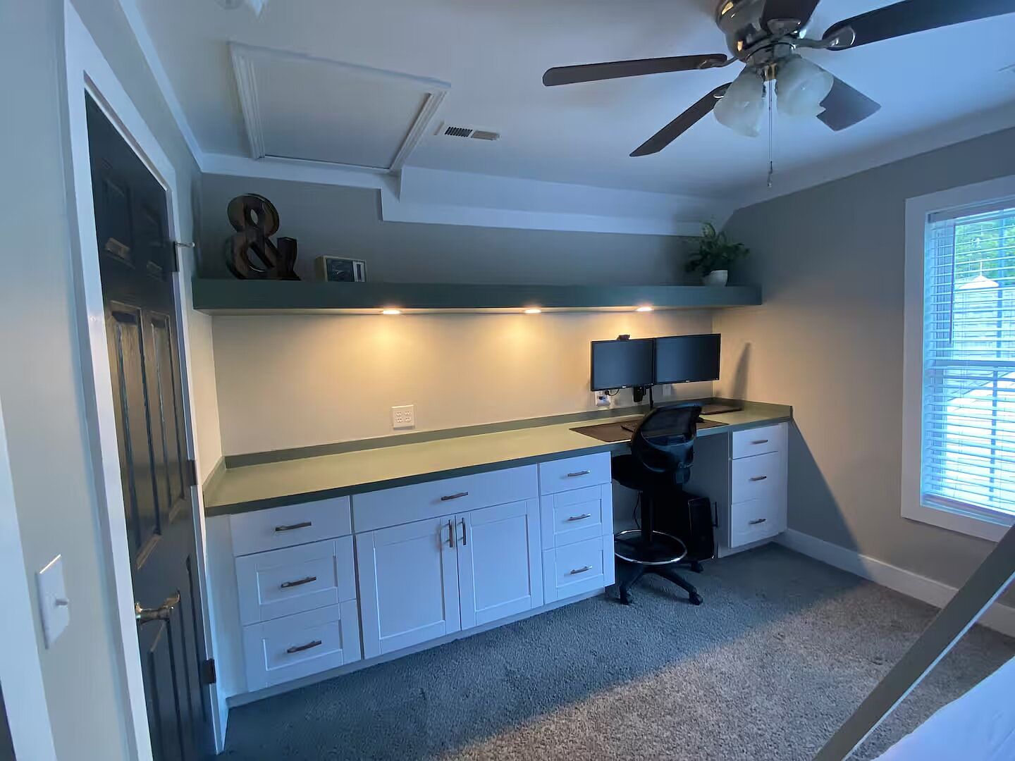 The built-in office wall with under-shelf lighting