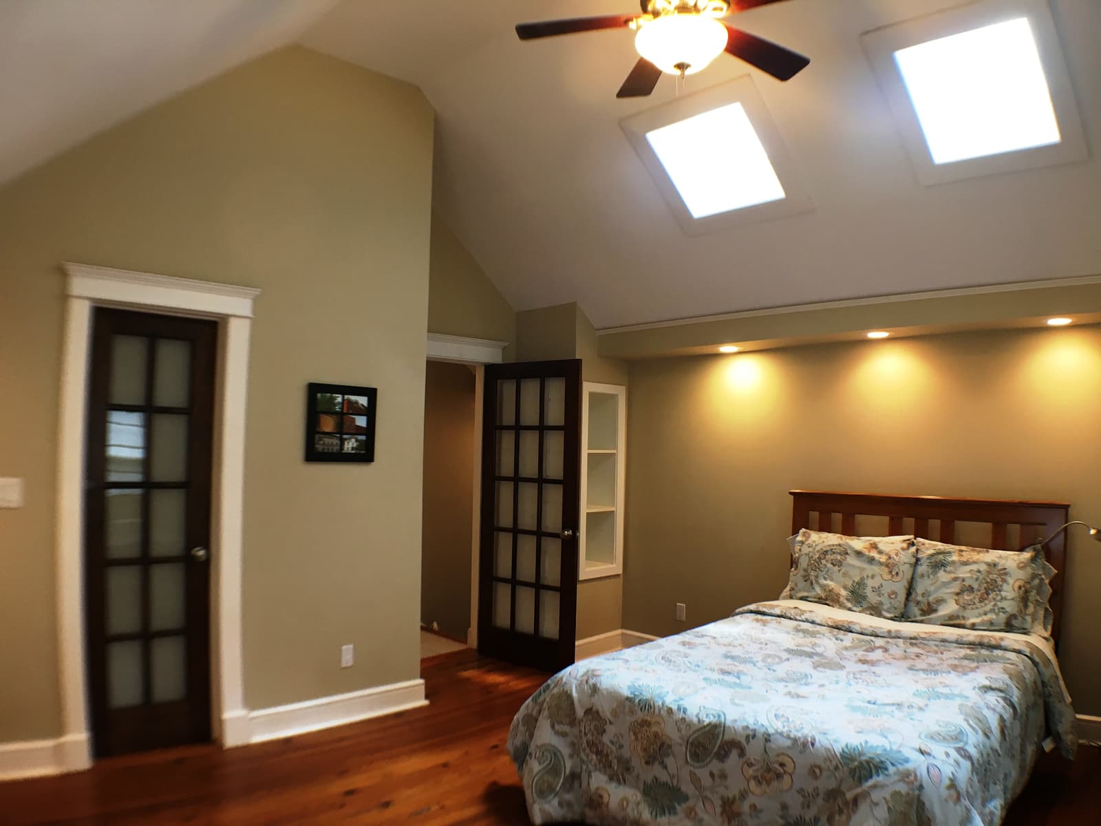 The bedroom's French doors and built-in shelving