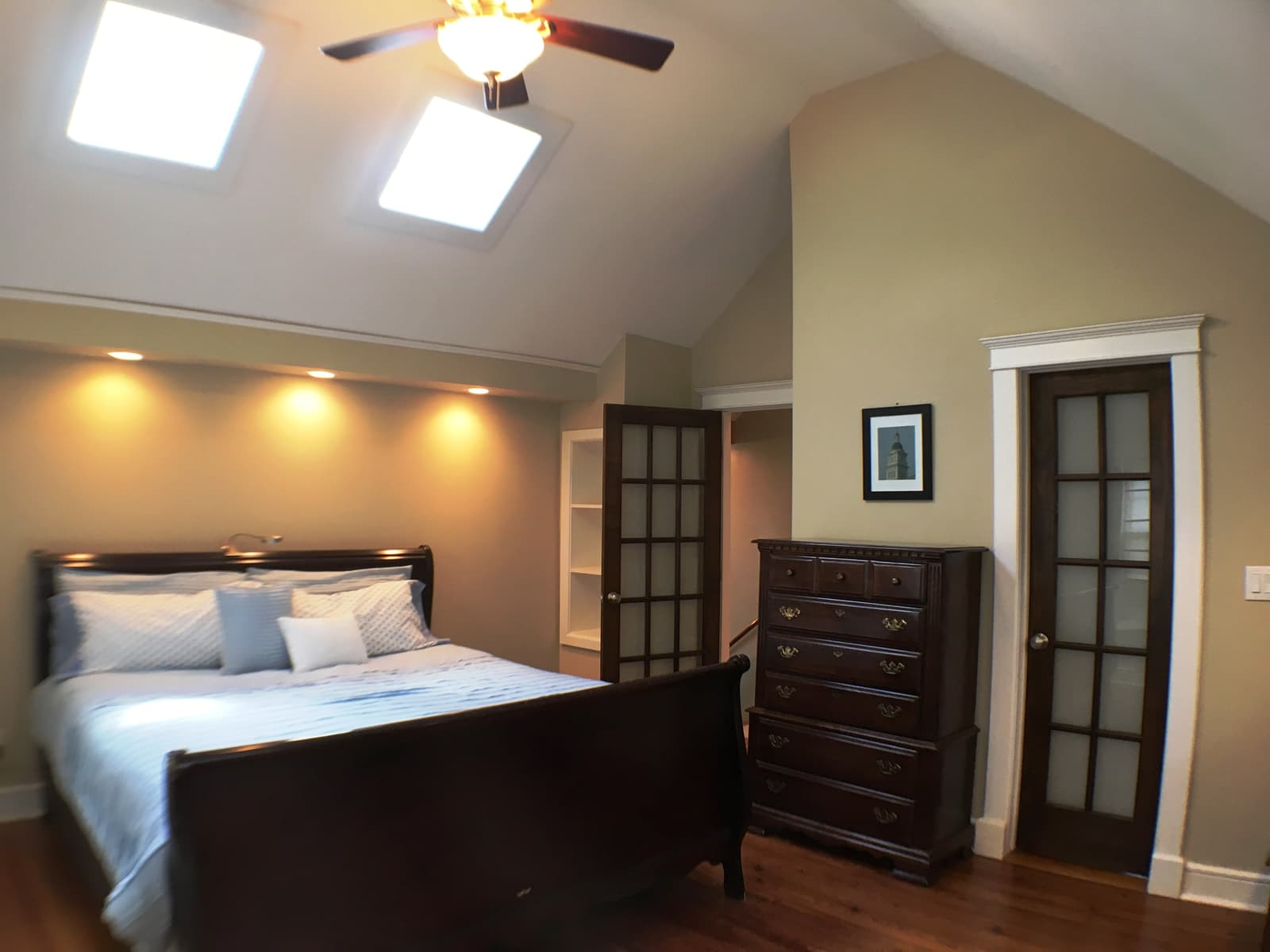 The bedroom's dresser wall and French doors to the landing