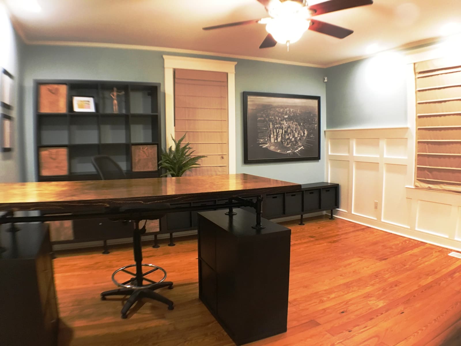 The office's wainscoting and roman shades