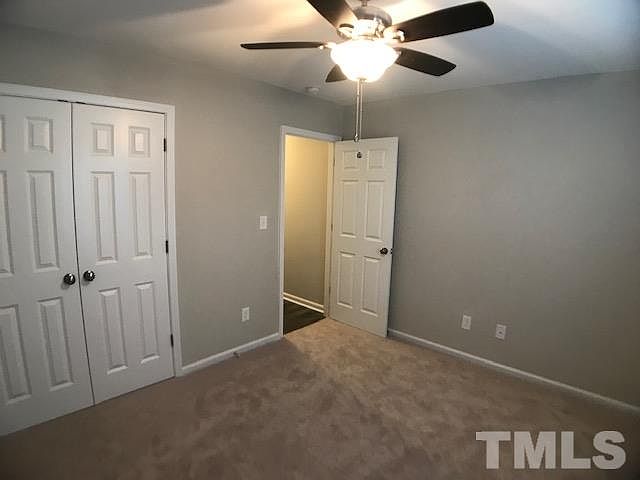 A bedroom with closet and hallway view